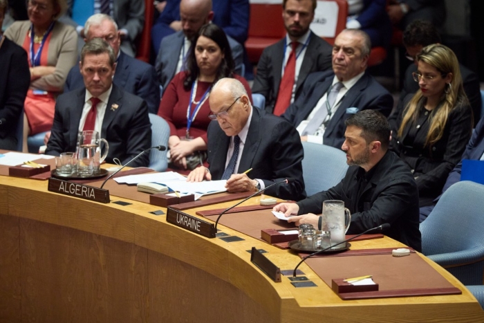 Ukrainian President Volodymyr Zelenskyy speaks at the United Nations Security Council meeting in New York, seated at the table marked ‘Ukraine’ alongside international delegates including Algeria.
