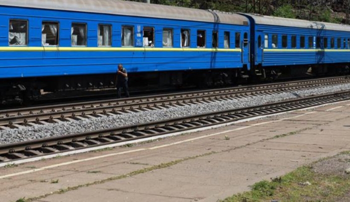 The photo depicts a Ukrainian train damaged following a Russian attack in June 2025, showing the physical impact on rail infrastructure and the challenges faced in maintaining transportation.