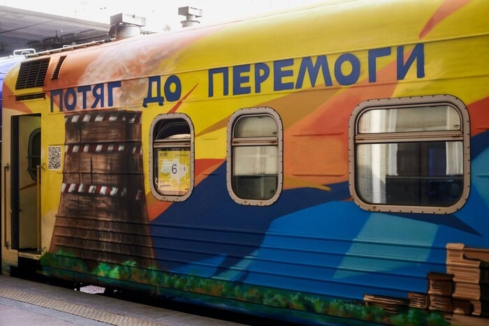 “The photo shows a brightly painted ‘Victory Train’ carriage, decorated by Ukrainian artists to honor the resilience of citizens and soldiers in occupied regions, turning the train into a moving symbol of resistance and hope.