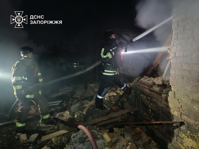SEO description:Firefighters from the State Emergency Service of Ukraine in Zaporizhzhia extinguish a fire at night amid the ruins of a destroyed building. The image shows rescuers in full protective gear working through heavy smoke, highlighting their bravery and dedication during emergency response efforts in war-affected areas of Ukraine.