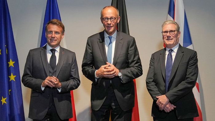 French President Emmanuel Macron, German Chancellor Friedrich Merz and British Prime Minister Keir Starmer are posing together during the NATO Summit in The Hague, Netherlands