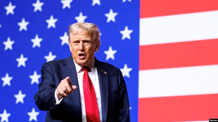 Donald Trump speaking at Quantico, Virginia, standing in front of the American flag during his address