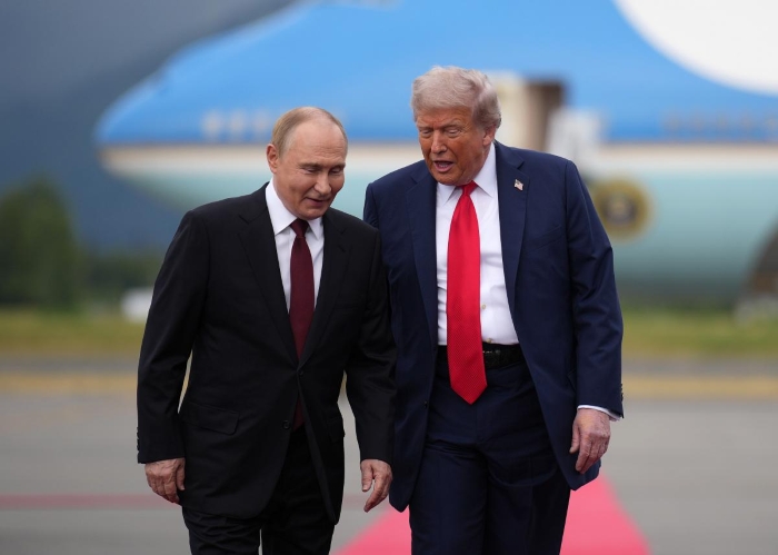 Donald Trump and Putin are walking and discussing something with smiles in Alaska in August, 2025