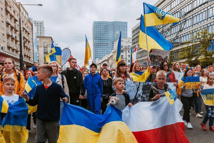**SEO description:**Ukrainian and Polish citizens take part in a solidarity march supporting Ukraine. People are holding Ukrainian and Polish flags, as well as banners calling for peace and unity. The demonstration takes place in a European city, symbolizing strong international support for Ukraine amid the ongoing war.