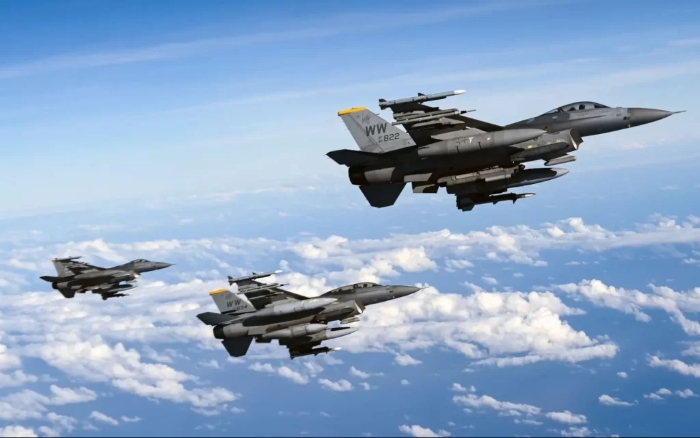 Three F-16 Fighting Falcons of the United States Air Force fly over the Pacific Ocean