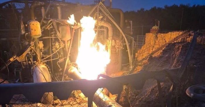 A nighttime image shows a fire at a gas pipeline station, with flames erupting from damaged equipment in Shostka, Sumy Region