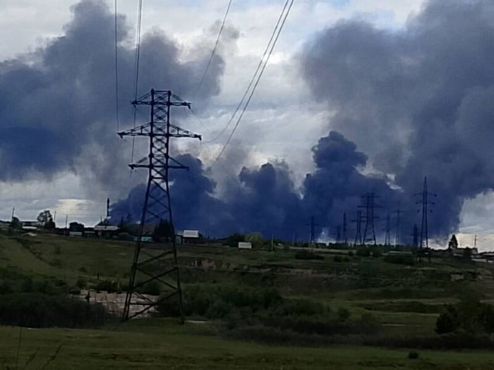 Image shows thick black smoke rising over an industrial area after a drone strike, part of Ukraine’s “Spider Web” operation