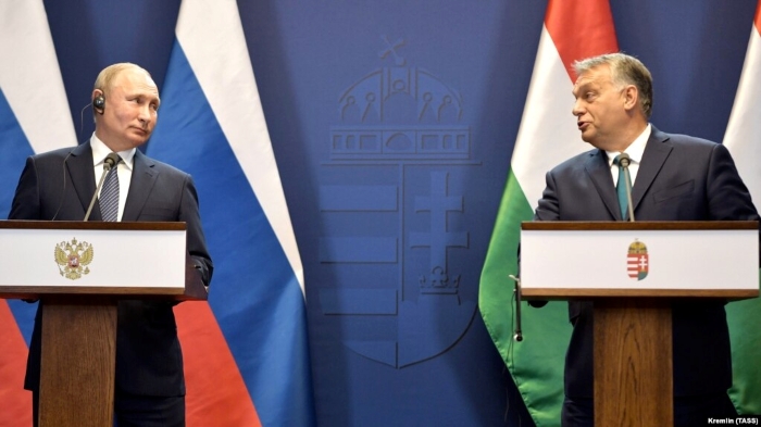 Hungarian Prime Minister Viktor Orban standing with Russian President Vladimir during their press conference