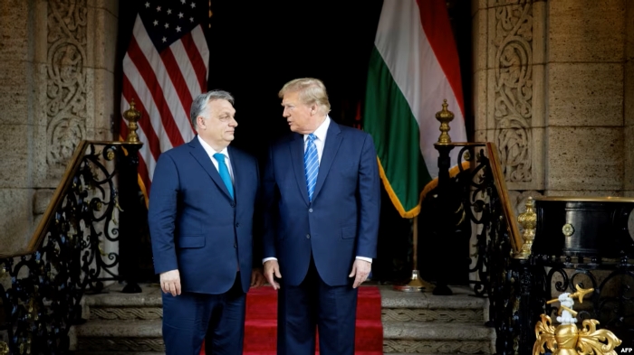 Hungarian Prime Minister Viktor Orban and the US President Donald Trump are standing in from of theit national flags