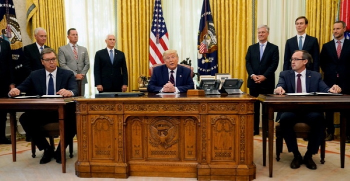 The leaders of Serbia and Kosovo sign the “Economic Normalization Agreement” at the White House in 2020, with the President of the United States present.