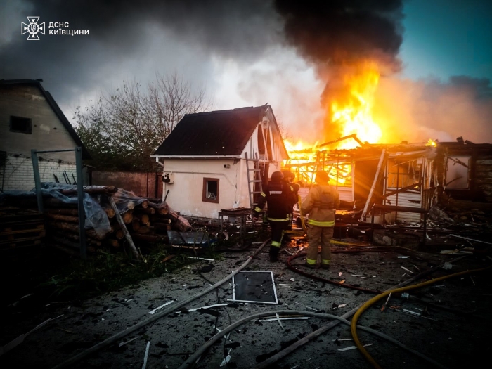 Ukrainian firefighters work to extinguish a massive blaze after a Russian missile strike on a residential area in the Kyiv region on October 22, 2025. The attack caused severe destruction to homes and infrastructure, with emergency services responding to fires amid ongoing Russian assaults across Ukraine.
