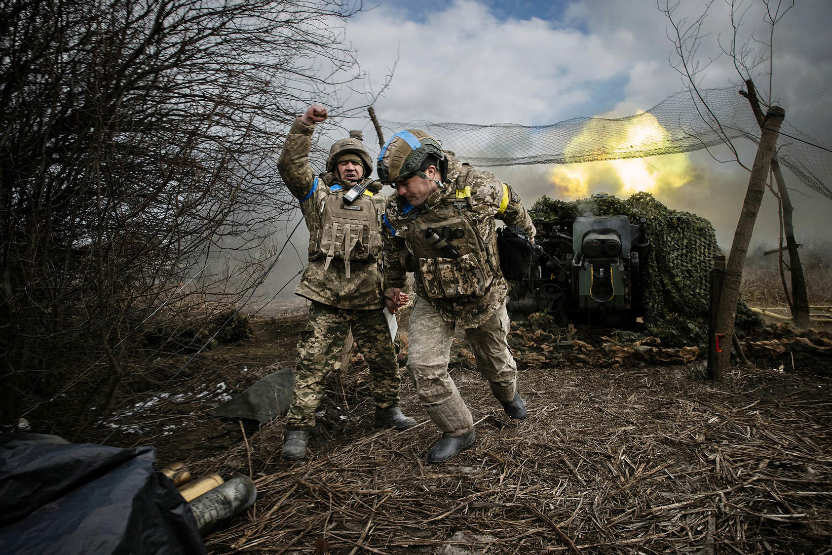 Ukrainian soldiers with the 31st Separate Mechanized Brigade fire a 122-millimeter howitzer D-30 at a Russian target in the Donetsk region of eastern Ukraine, Feb. 20, 2024. / Tyler Hicks, The New York Times