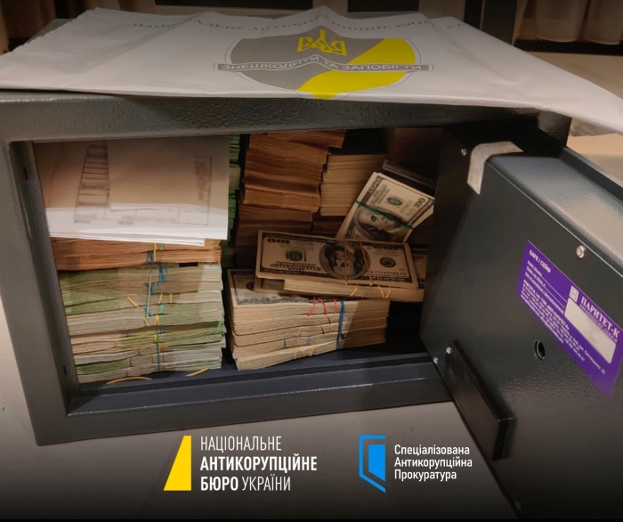 Open safe filled with large bundles of cash discovered during an anti-corruption operation in Ukraine