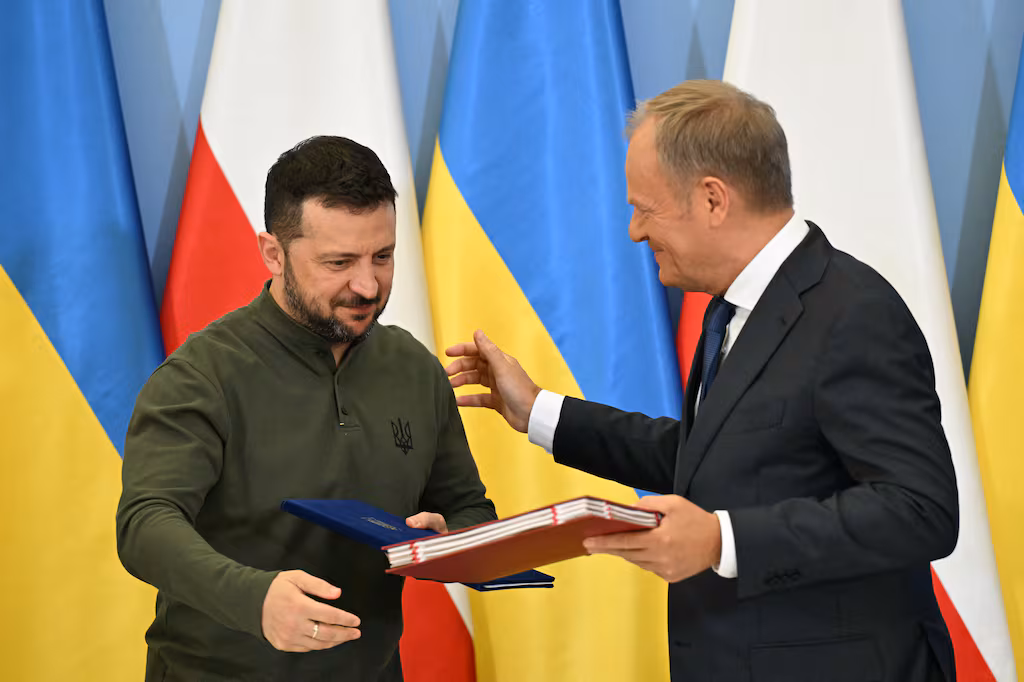 Ukrainian President Volodymyr Zelensky (L) stands next to Polish Prime Minister Donald Tusk after signing an agreement in Warsaw, Poland on July 8, 2024, ahead of NATO's 75th anniversary leader's summit / Sergei Gapon / AFP via Getty Images