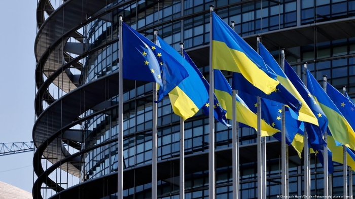 The picture shows Ukraine`s and the EU flags on the background of European Parliament