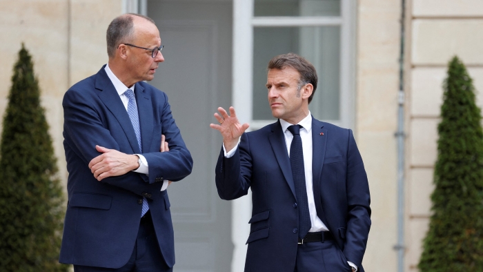 The picture portrays French President Emmanuel Macron talks with German Chancellor Friedrich Merz in the garden of the Élysée Palace in Paris