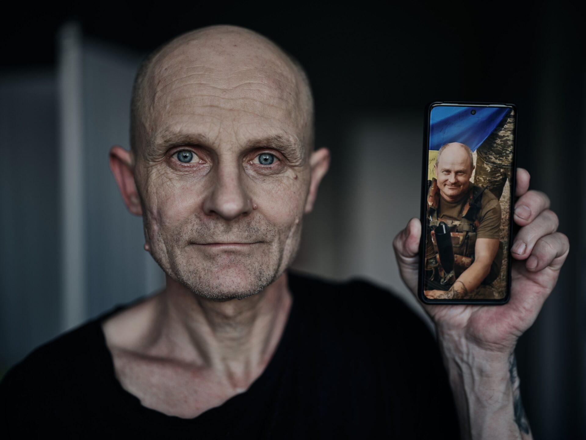 A Ukrainian soldier who was previously held captive by Russian forces shows a picture of himself prior to captivity, while undergoing rehabilitation on June 6, 2024 in Ukraine. Photo by Kostiantyn Liberov/Libkos/Getty Images.