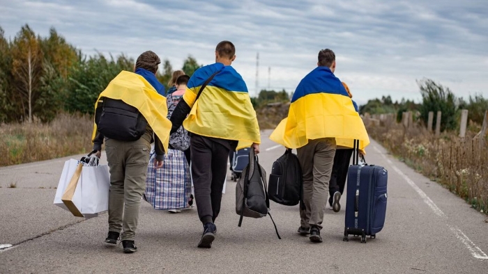 The picture shows children returning to Ukraine from Russiawith flags
