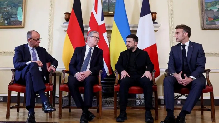 The picture portrays German Federal Chancellor Friedrich Merz, British Prime Minister Keir Starmer, Ukraine`s President Volodymyr Zelenskyy, anf French President Emmanuel Macron during the meeting in London on December 8 sitting in fromt of the national flags