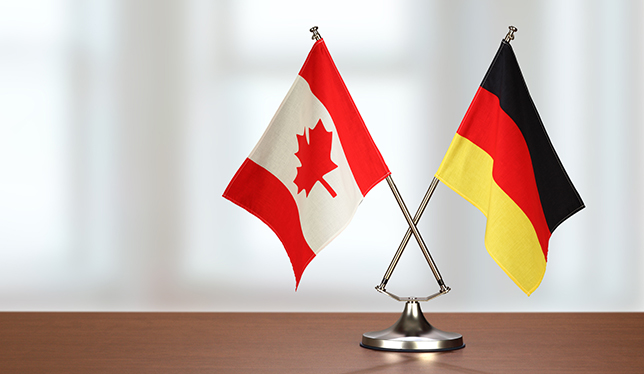 Two crossed national flags on wooden table / Open Sources