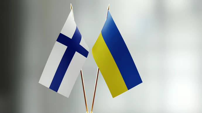 Flags of Ukraine and Finland depicted on the table