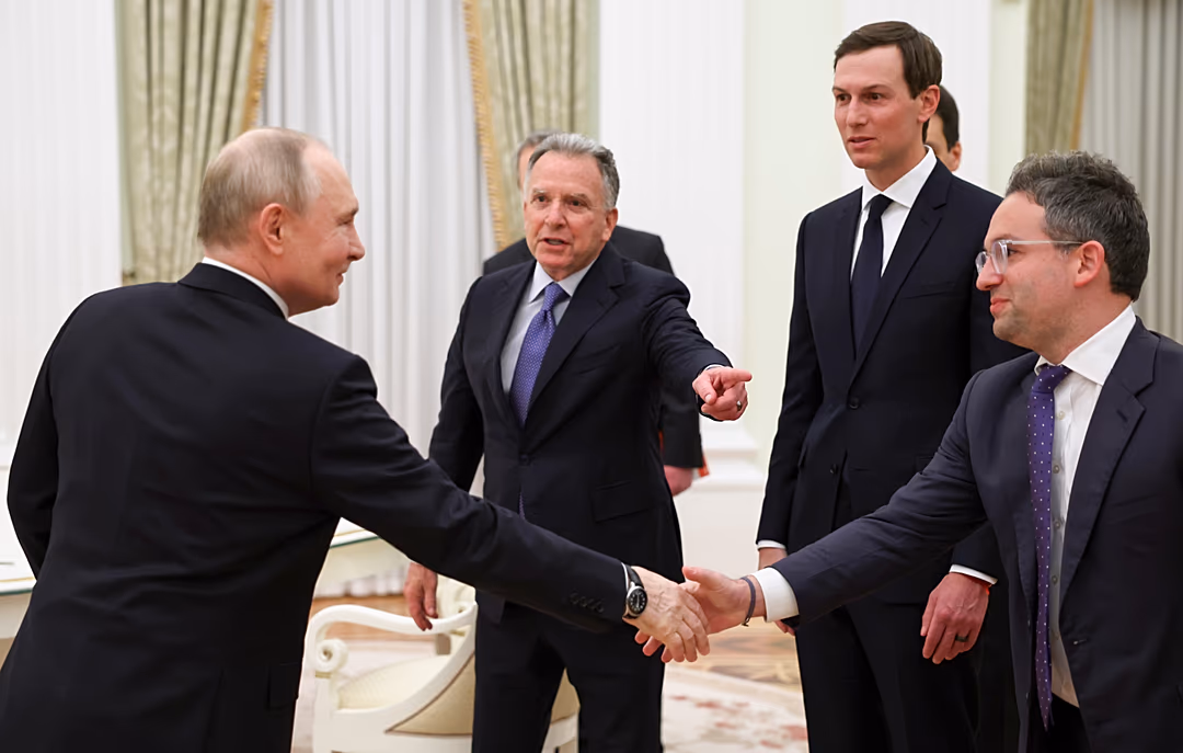 Vladimir Putin greets Donald Trump's envoys at the Senate Palace of the Kremlin.