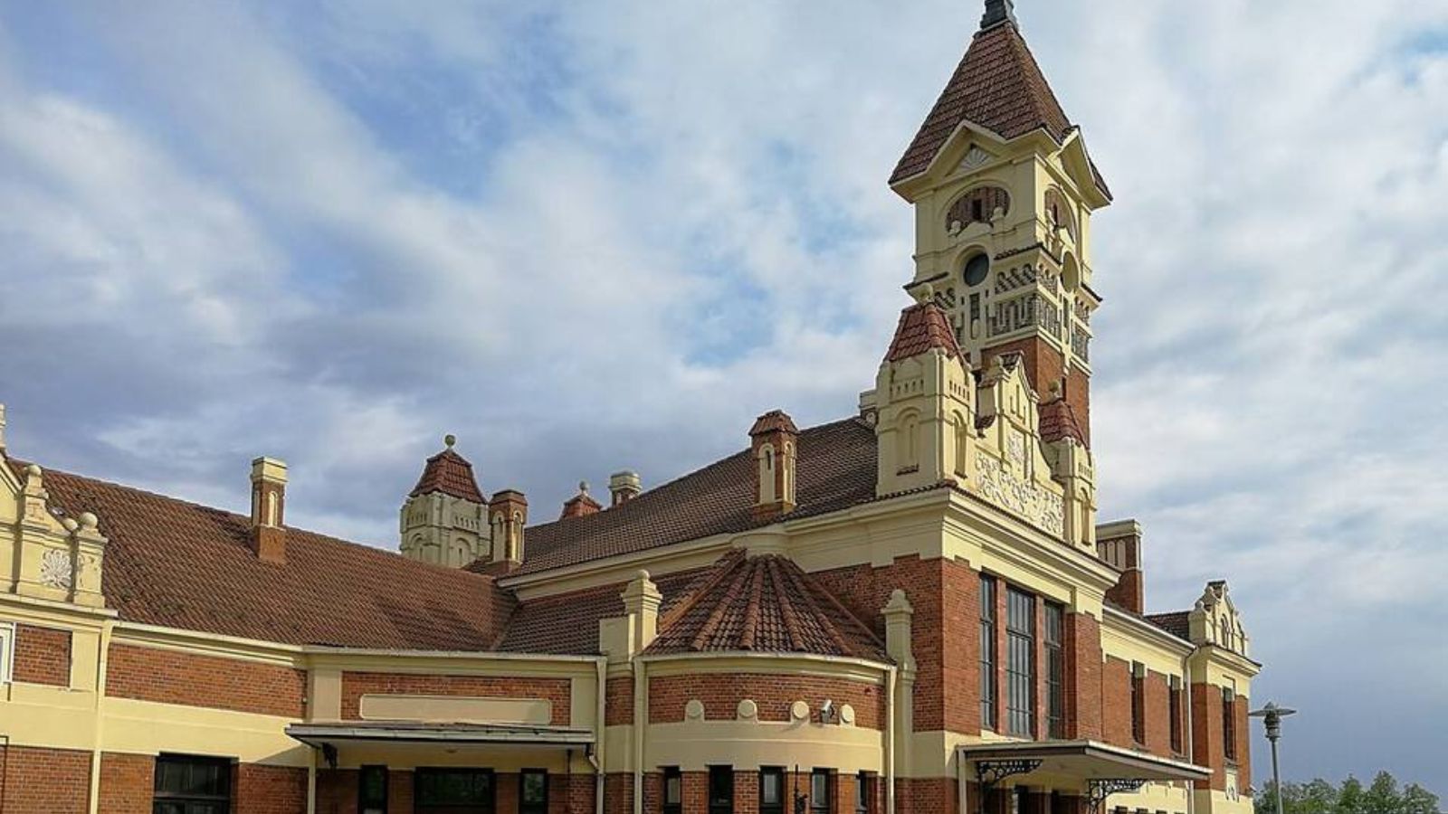 The railway station building in Marijampolė, Lithuania, featuring distinctive architecture and a tower.