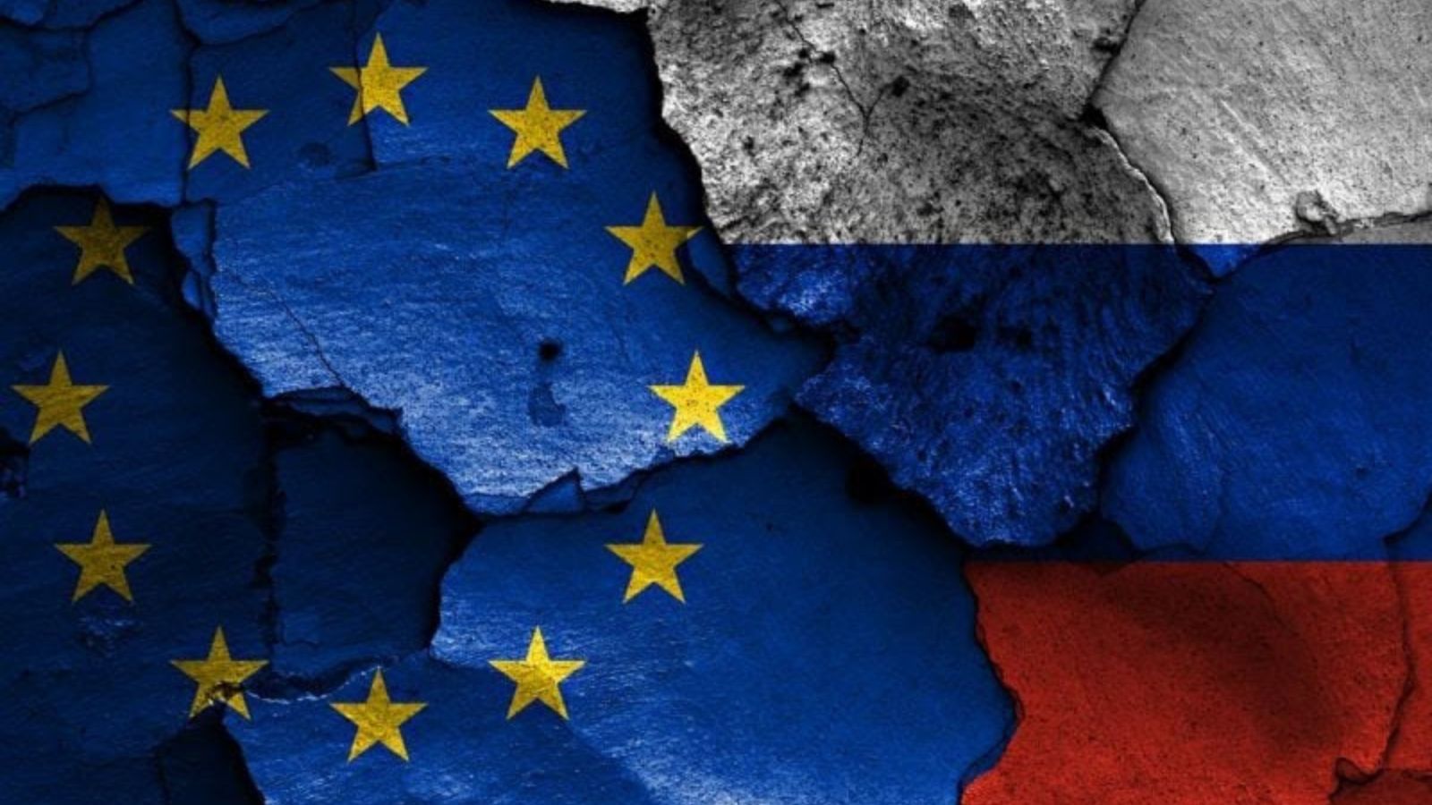 Image of cracks on a wall featuring the flags of the European Union and Russia, symbolizing conflict.