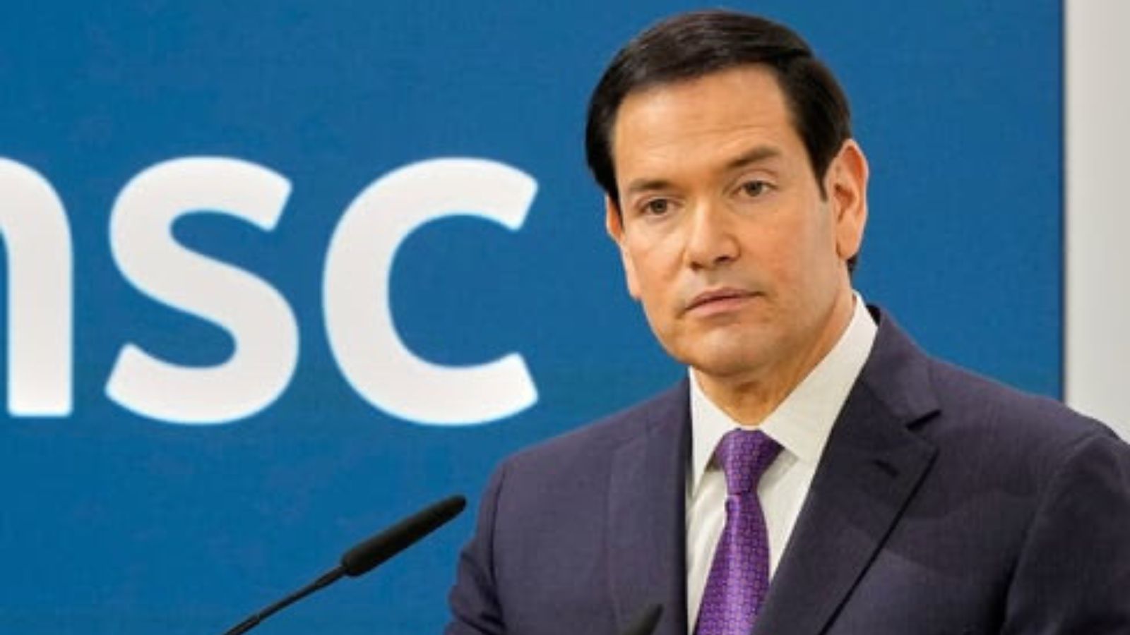 Portrait of US Secretary of State Marco Rubio speaking in front of the MSC logo.