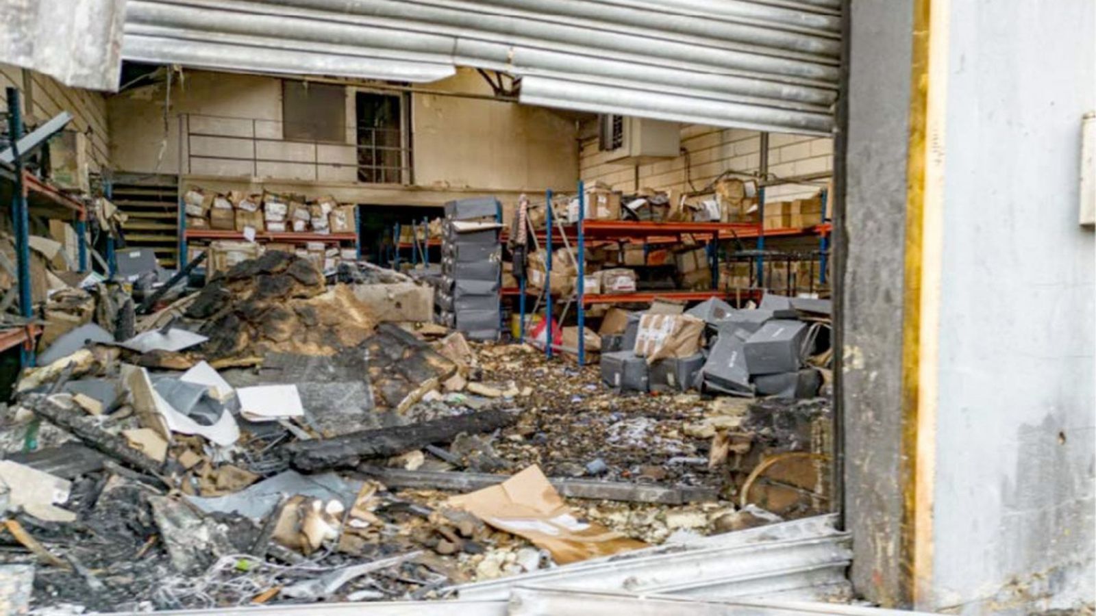 The charred remains of a London warehouse building after an arson attack by a sabotage group.