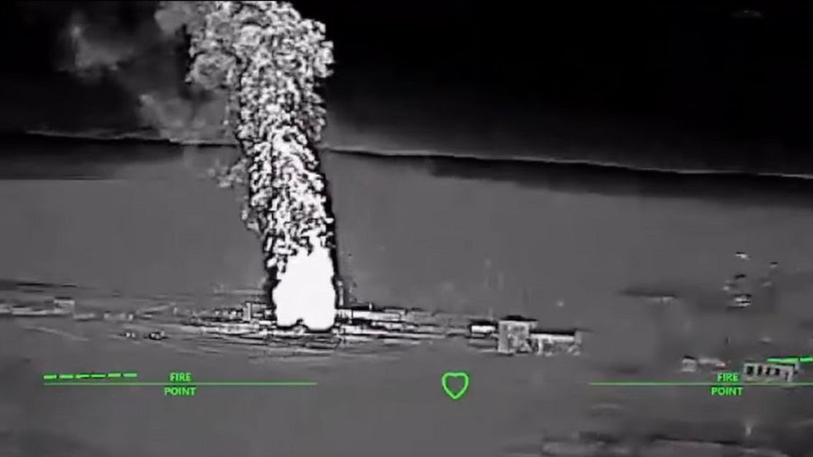 Thermal image (black and white with a green reticle) shows a high column of white (hot) smoke rising above a burning industrial facility.