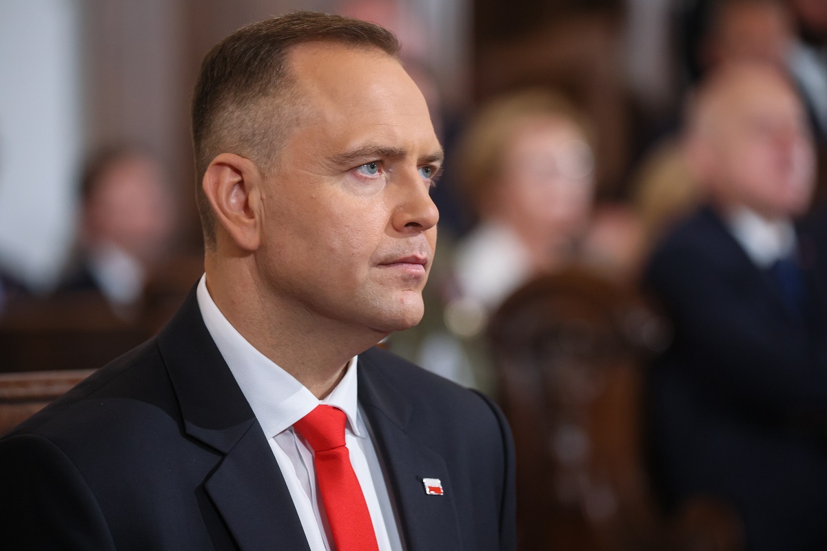 Karol Nawrocki sits against the background of other government officials