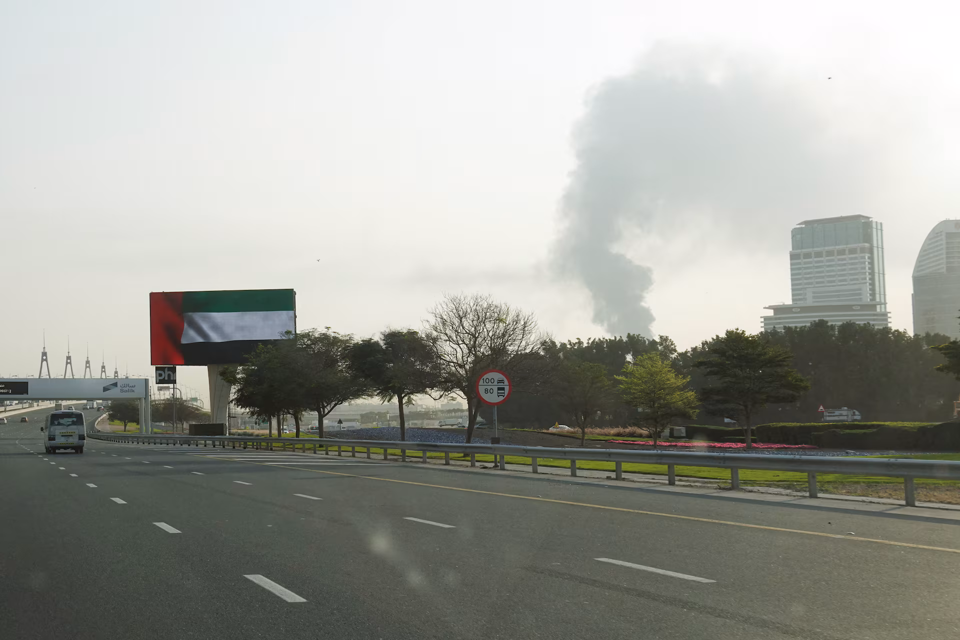 Smoke rising from an area near Dubai International Airport is seen through the windshield of a car after a drone hit a fuel tank, Dubai authorities said, amid the conflict between the United States and Israel with Iran, Dubai, United Arab Emirates, March 16, 2026