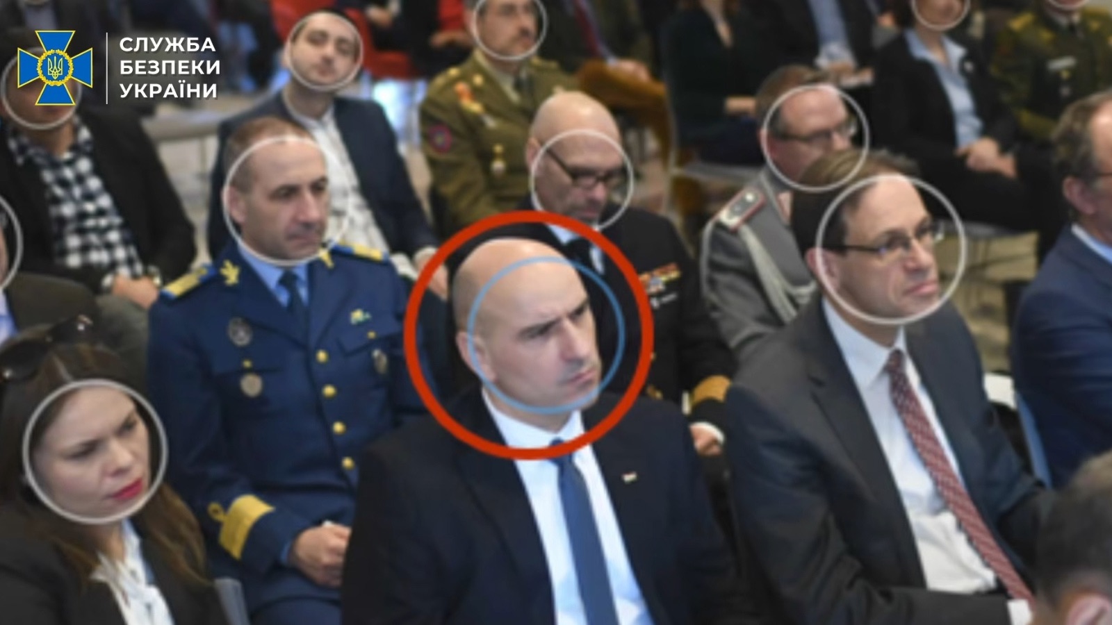 Photo of Hungarian intelligence officer Zoltan Andre, circled in red, at a meeting in a conference hall