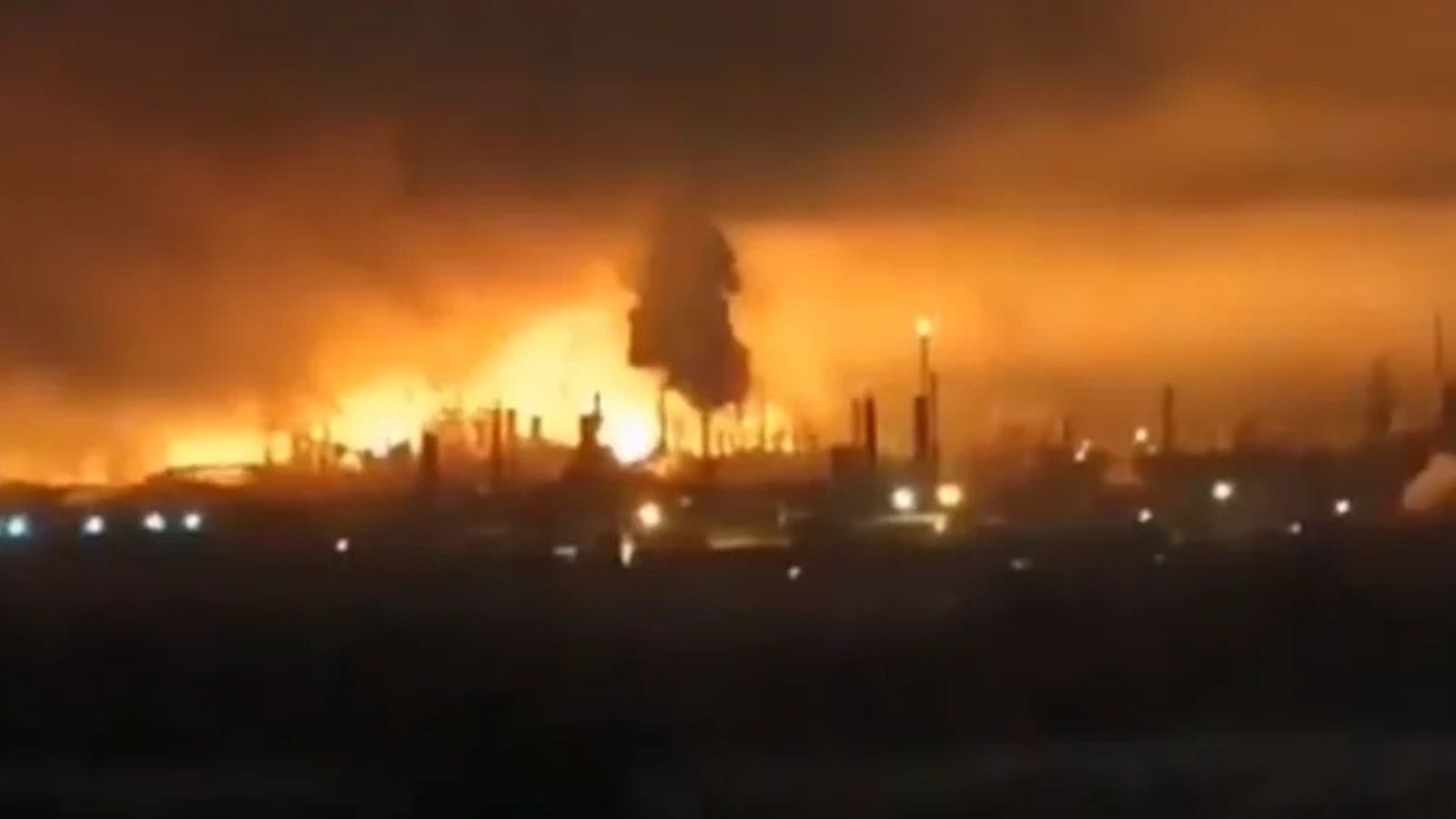 Ukrainian Forces Strike Strategic Russian Refinery and Oil Port A nighttime shot showing flames and smoke above the industrial Lukoil refinery in Kstovo. The plant is visible in the background against the dark night sky.