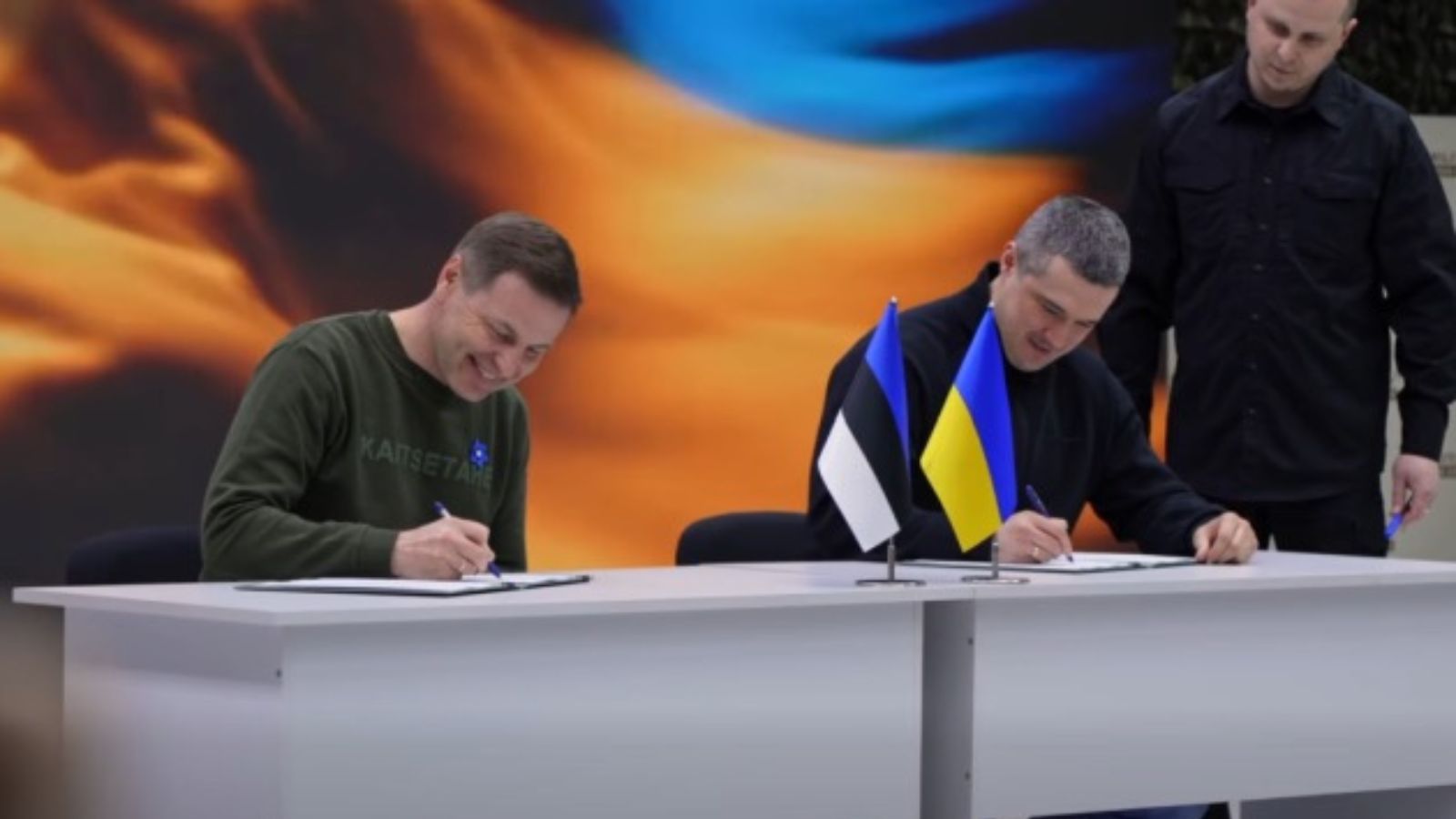 Міністр оборони Естонії Ганно Певкур (ліворуч) та Міністр оборони України Михайло Федоров (праворуч) сидять за столом і підписують документи.