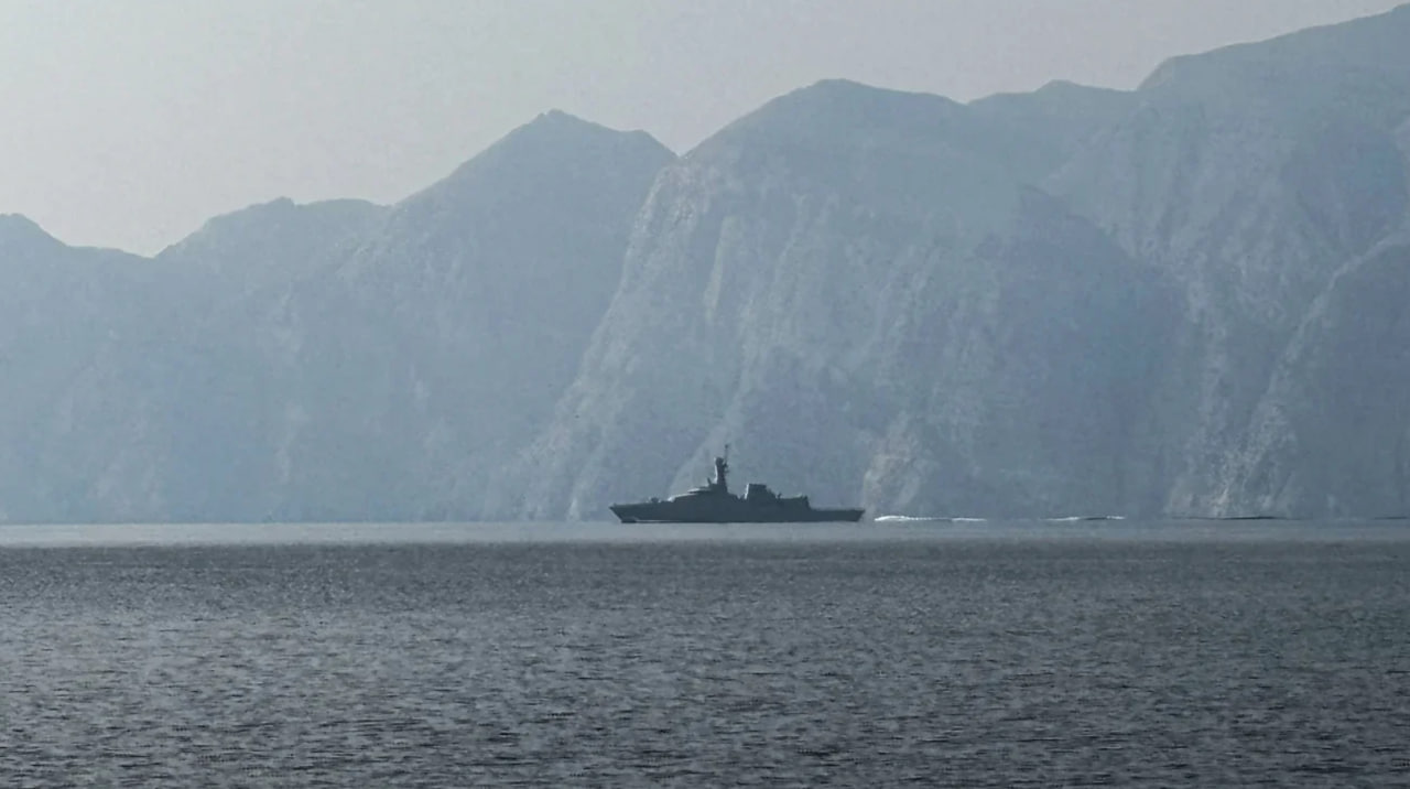 A warship sails through the Strait of Hormuz