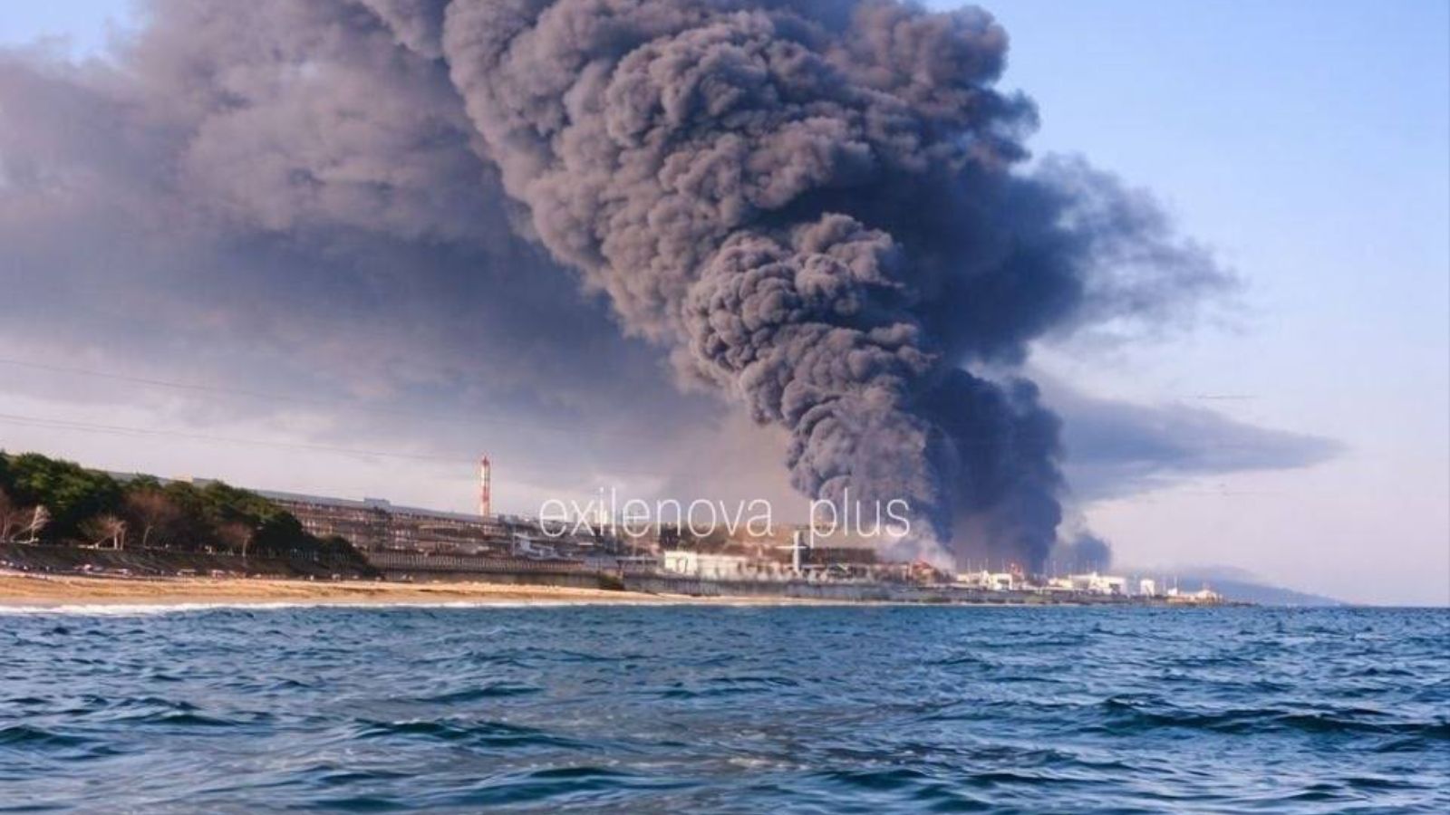 A large cloud of thick black smoke rising above the Tuapse oil refinery after an overnight attack, viewed from the sea.